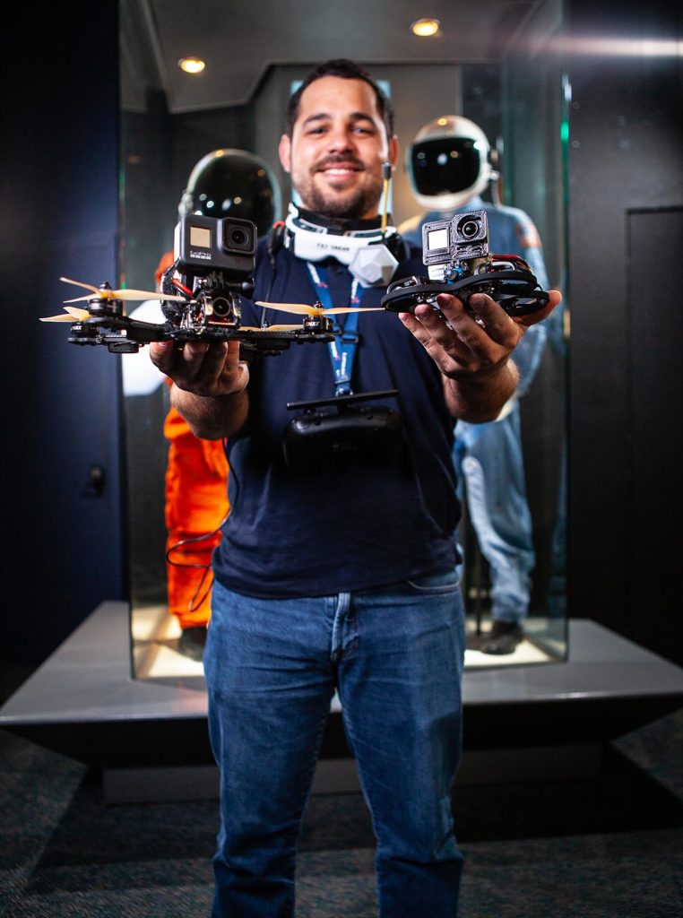 Alberto Diaz holding two FPV drones