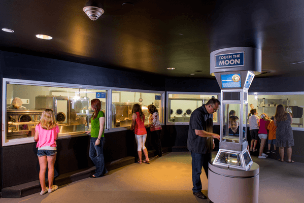 Enter the Lunar Vault where you can touch a real moon rock and view the largest collection of moon rocks on public display in the world. Study and analysis of these lunar samples has unlocked the mysteries of the moon thanks to the Apollo missions that collected them. Photo courtesy of Space Center Houston.